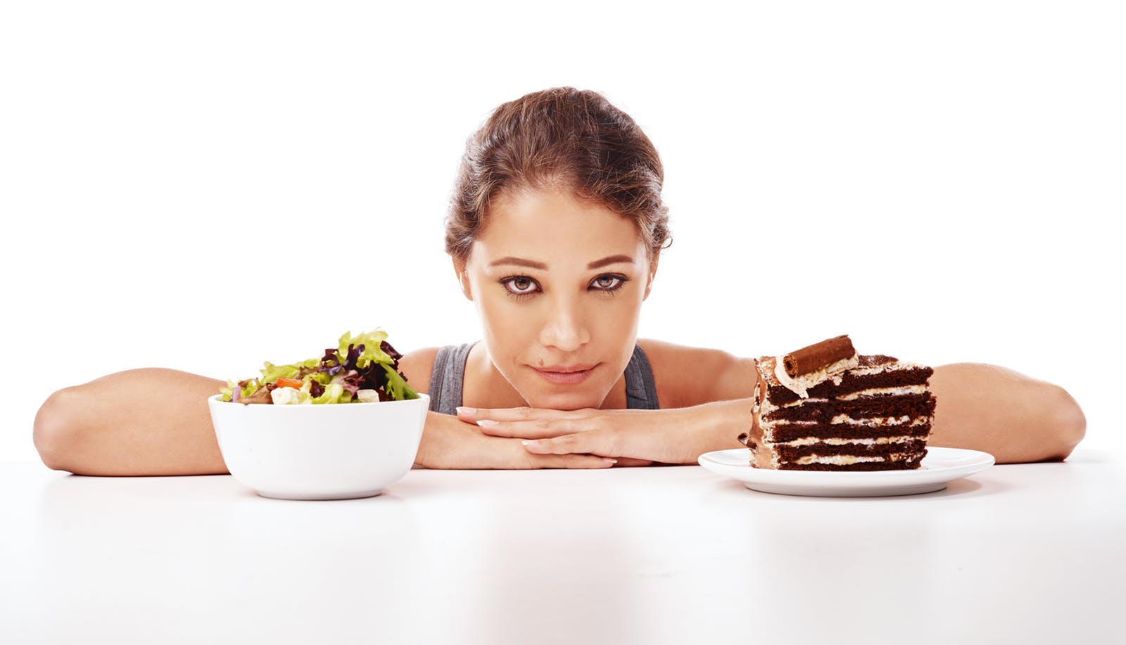 Woman-choosing-between-salad-or-chocolate-cake